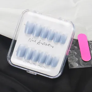 Short blue solid press-on nail kit with glue stickers and pink file in clear box