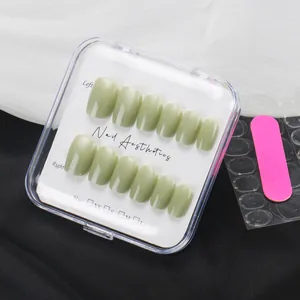 Detail of matcha green press-on nails set with glitter finish in transparent storage box