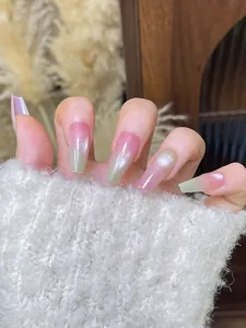 Close-up of pink and green gradient cat-eye coffin nails with glitter finish and texture
