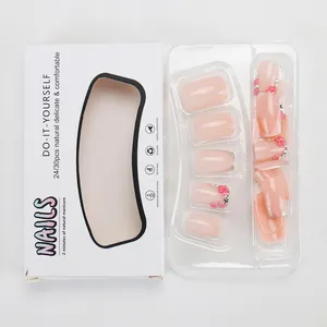 Kit unghie finte rosa con fiori 3D e strass in una confezione minimalista