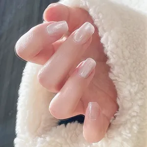 Short square pearlescent white press-on nails with shimmering cat eye texture
