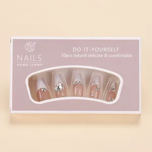 French gradient press-on nails with rhinestones and pearls in a lavender display box
