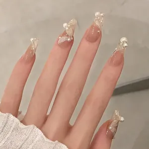 Elegant long ballet-style press-on nails with nude pink base and 3D white pearl accents