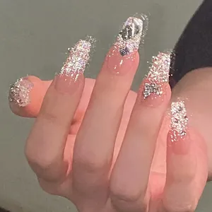 Macro detail of pink glitter nails with silver butterfly and diamond rhinestones