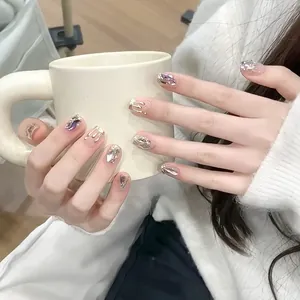 Nude pink French press-on nails with 3D silver chrome details and sparkling rhinestones