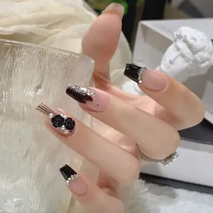 Detail of long coffin press-on nails featuring 3D roses, pearls and crystals
