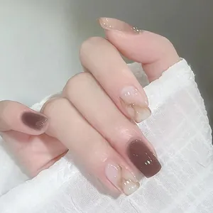 Close-up of champagne amber marble press-on nails with dark brown glossy finish