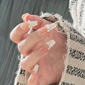 French ombre press-on nails in creamy white with pearls and crystals for a sweet style