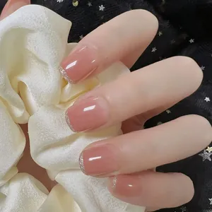 Close-up of nude pink aurora press-on nails with silver glitter gradient and almond shape