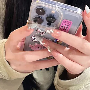 Close-up of long coffin nails with pink aurora cat eye finish and moon charms