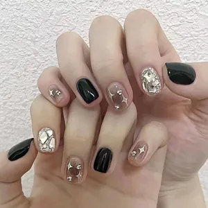 Short round press-on nails in black and silver with aurora glitter and star charms
