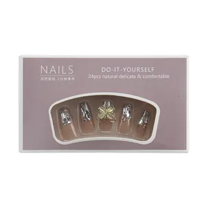 Nude aurora press-on nails with champagne gold glitter, rhinestones and clover gem
