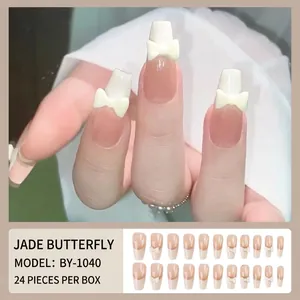French press-on nails with nude pink base, milky white tips and 3D white bow accents