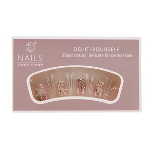 Short white press-on nails with 3D bunny and pearl designs in a pink presentation box