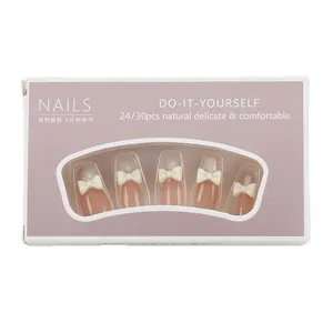 Press-on nails in creamy white French style with 3D bows and ballet coffin shape