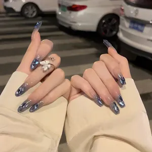 Detailed view of long coffin blue gradient press-on nails with rhinestones and glitters