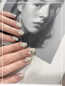 Detailed view of handmade short French press-on nails with luxury rhinestones and pearls