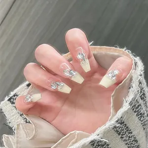 Macro detail of coffin shaped press-on nails with silver glitter and rhinestone accents