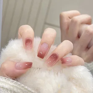 Brown and nude ombre square oval press-on nails with glossy gel finish on white fur