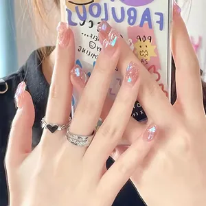 Detail shot of holographic pink press-on nails with glitter aurora waves on fingers