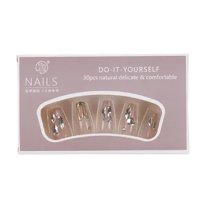 30-piece press-on nail set in nude brown with gold glitter and 3D rhinestone accents