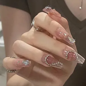 Handmade press-on nails with heart rhinestones and silver glitter in long coffin shape