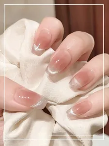 Detail of short ballet nude blush press-on nails with silver glitter french tips