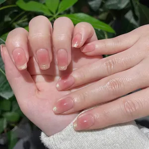 Short French blush pink gradient press-on nails with silver glitter tips on hand