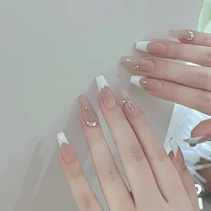 Detail von sargförmigen Kunstnägeln mit weißen French Tips und silbernen Strass-Akzenten