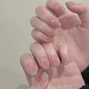 Detail view of short square press-on nails with pink blush and sky blue gradient design