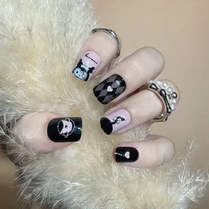 Detail of pink and black Kuromi press-on nails featuring heart and argyle patterns
