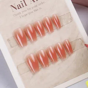 Press-on nail set with peach pink gradient on long coffin ballerina shape