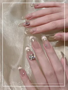 Macro detail of long square cat eye nails with silver glitter and large heart-shaped crystals