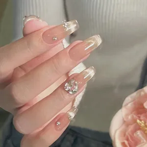 Pink cat eye press-on nails with silver glitter rhinestones and large heart-shaped crystal