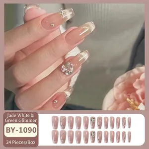 Glossy nude pink gradient press-on nails with sparkling rhinestones and glitter finish