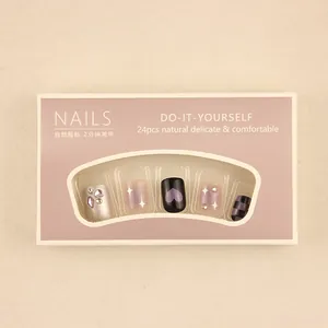Detail of 24pcs press-on nail kit with silver rhinestones and purple heart designs