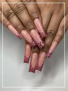 Detailed view of long square wine red press-on nails with glitter and pink hearts