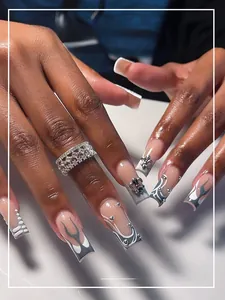 Detail of medium-long coffin press-on nails with grey flame art and metallic lily charm