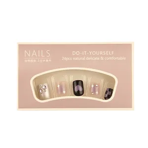 Press-on nail set with 24 pieces featuring silver rhinestones and purple heart designs