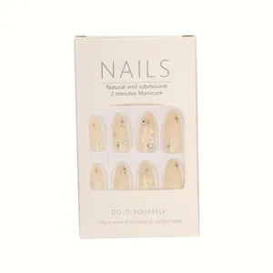 Press-on nails set with nude base, black stars, and butterfly rhinestones in box