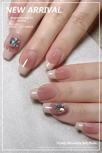 Macro detail of glossy nude French press-on nails with luxury crystal rhinestone accents