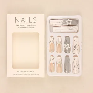 Long white star false nails with flame patterns, rhinestones and pearl star charms