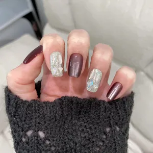 Detailed view of deep purple mirror finish and brown cat-eye glitter press-on nails