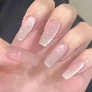 Macro detail of long ballerina press-on nails with nude pink cat-eye glitter finish