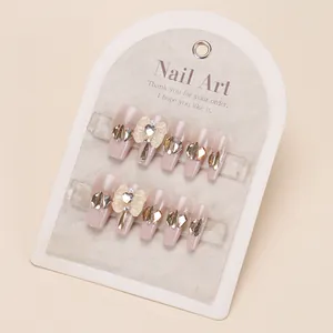 Press-on nail set in champagne gold nude pink with glitter diamonds and 3D bow design