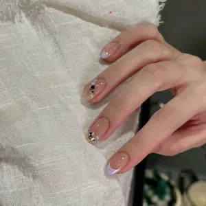 Detailed view of handmade press-on nails with lavender French tips and crystal 3D gems
