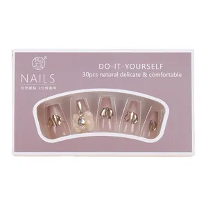 Nude pink press-on nails set with champagne gold glitter and 3D bowknot decorations