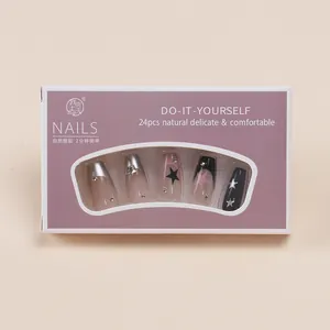 Detail view of 24pcs long coffin press-on nails with stars and rhinestones in box