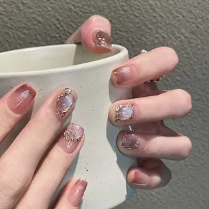Macro detail of gradient blush press-on nails with silver glitter and liquid metal edge