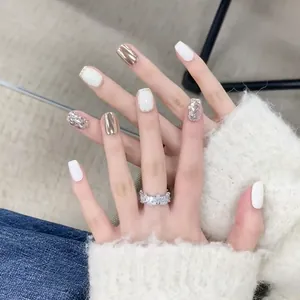 Detail of silver glitter and mirror nails with a sparkling rectangular gem ring